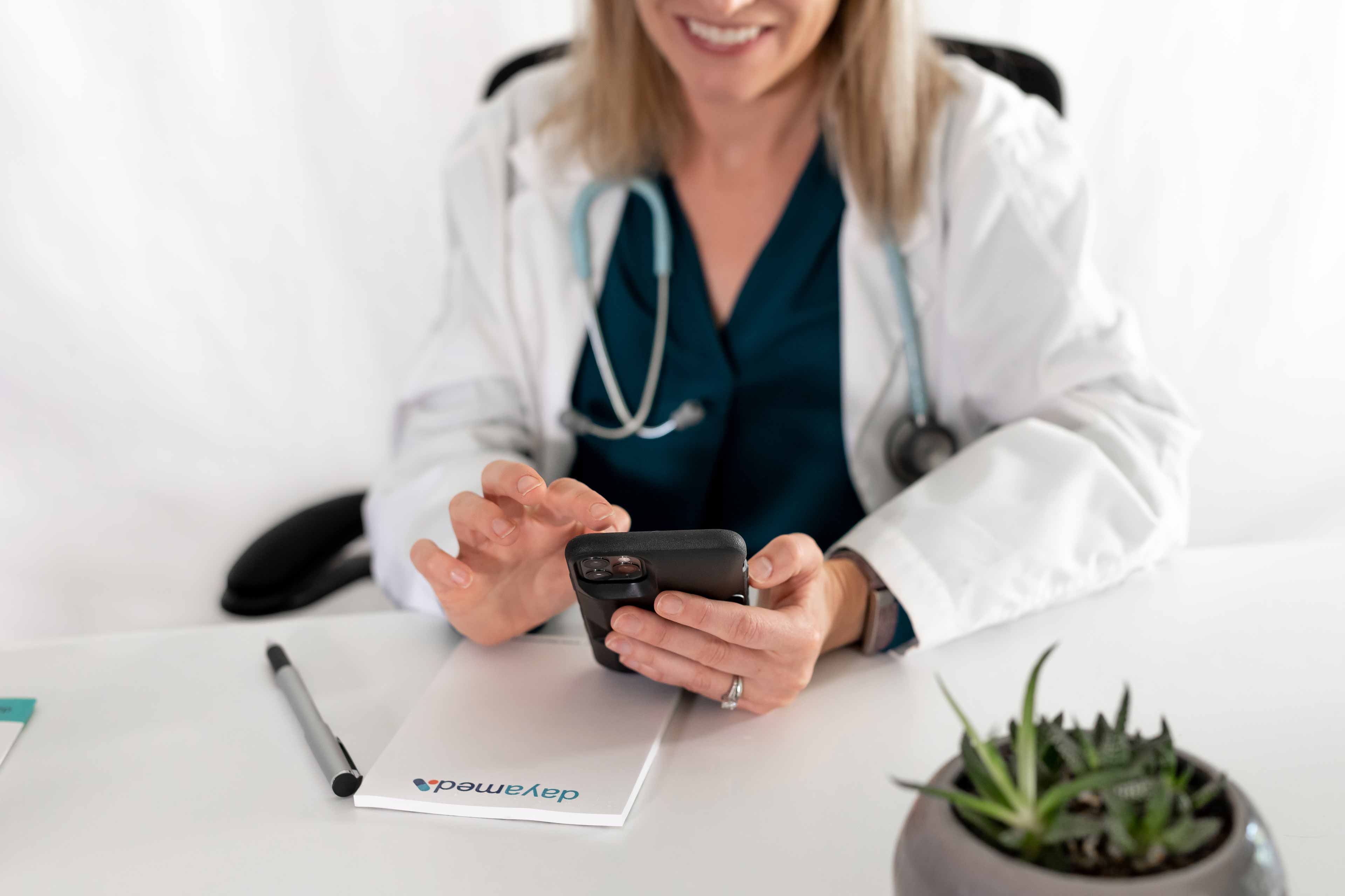 nurse lady using her phone to contact dayamed and schedule a demo